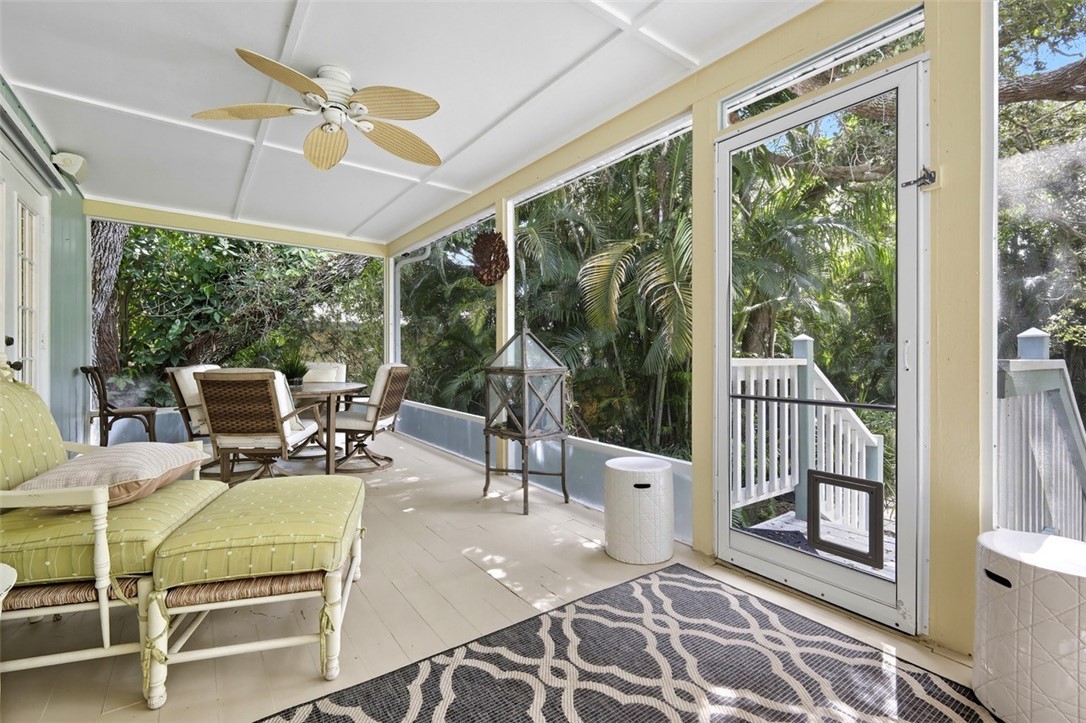 902 Tides Road Vero Beach, FL 32963 - Photo 21 of 25 a dining room with furniture water view and a floor to ceiling window