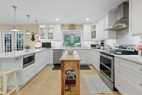a kitchen with a stove a sink and a refrigerator
