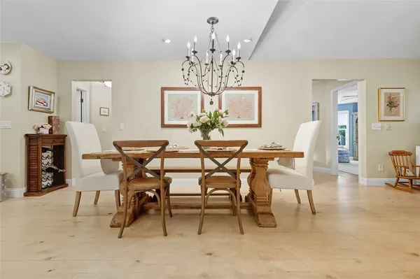a view of a dining room with furniture and chandelier