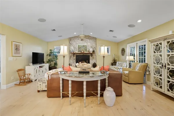 a living room with furniture a flat screen tv and a table