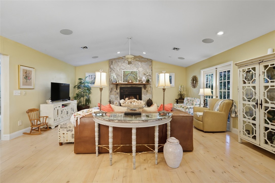902 Tides Road Vero Beach, FL 32963 - Photo 7 of 25 a living room with furniture a flat screen tv and a table