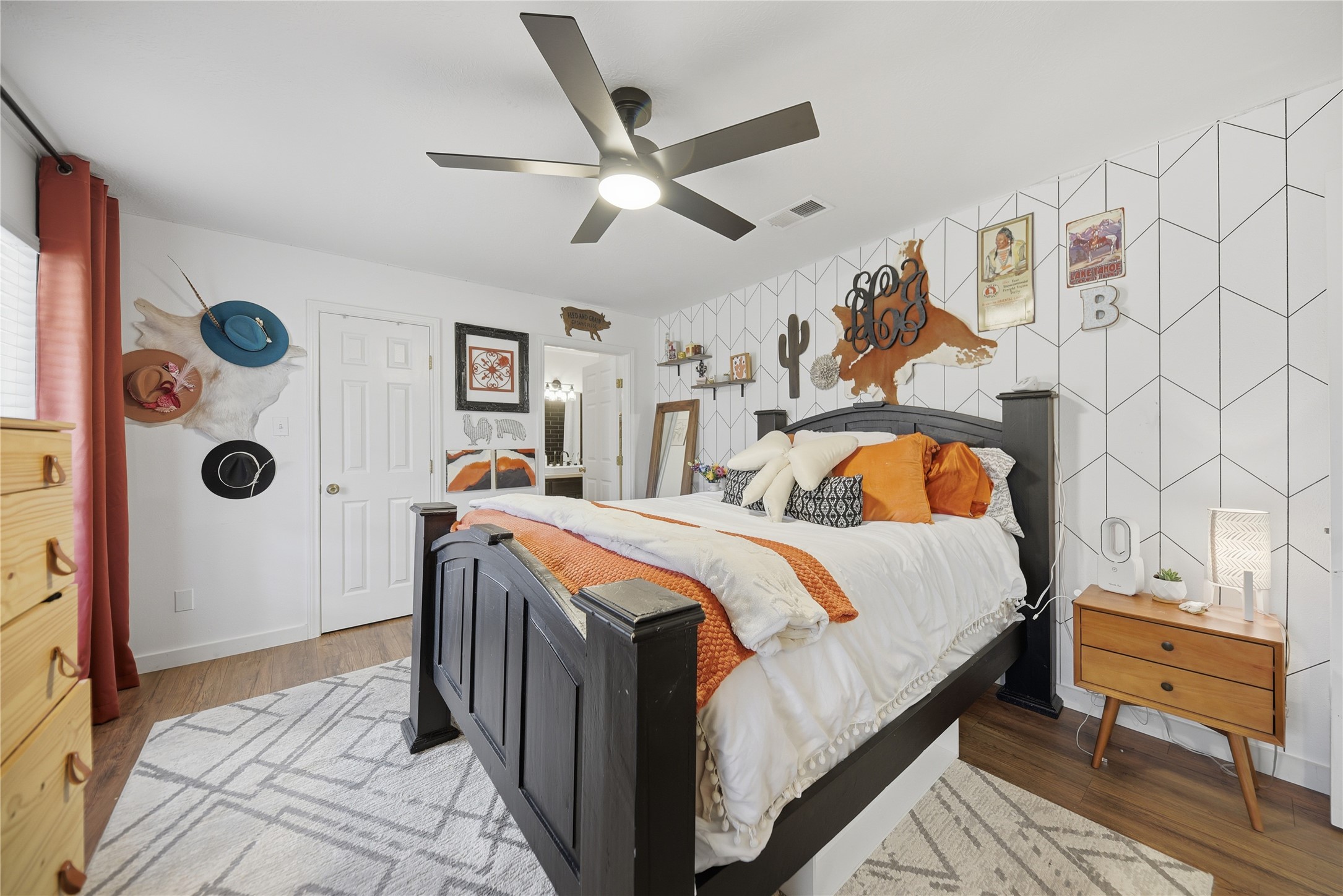 540 Hickory Creek Road Bellville, TX 77418 - Photo 15 of 49 a bedroom with a bed and a chandelier