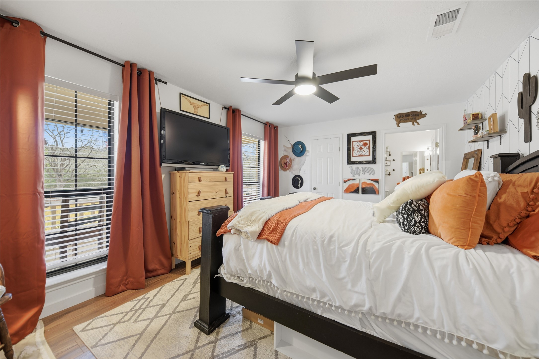 540 Hickory Creek Road Bellville, TX 77418 - Photo 17 of 49 a bedroom with a bed and a flat screen tv