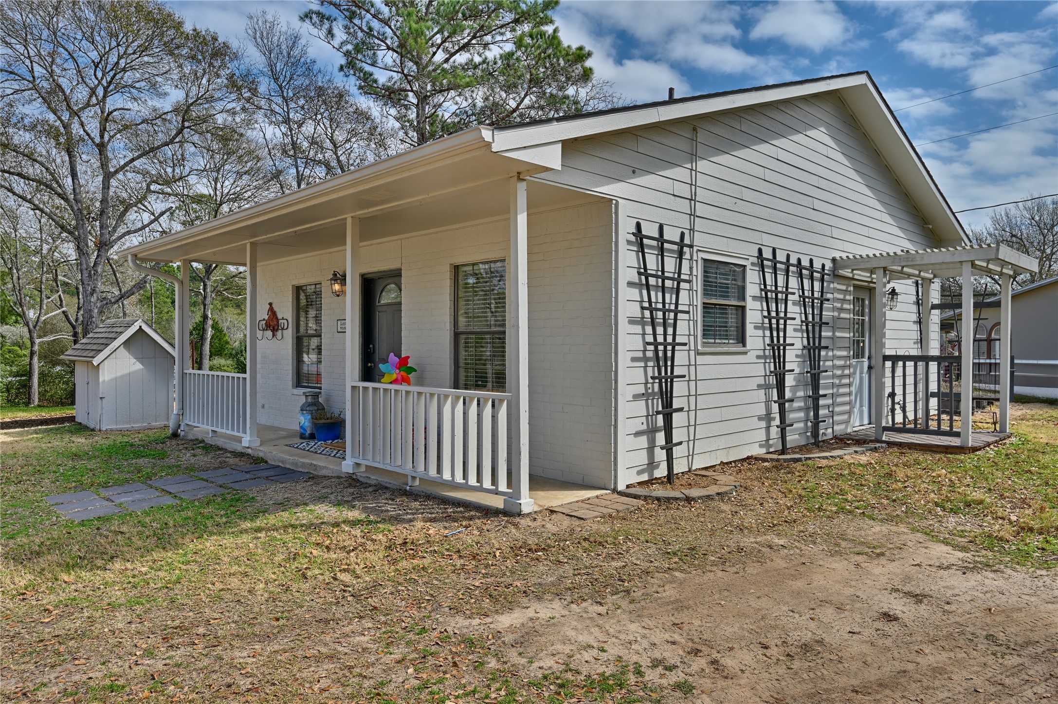 540 Hickory Creek Road Bellville, TX 77418 - Photo 35 of 49 a view of a small house with wooden fence and large trees