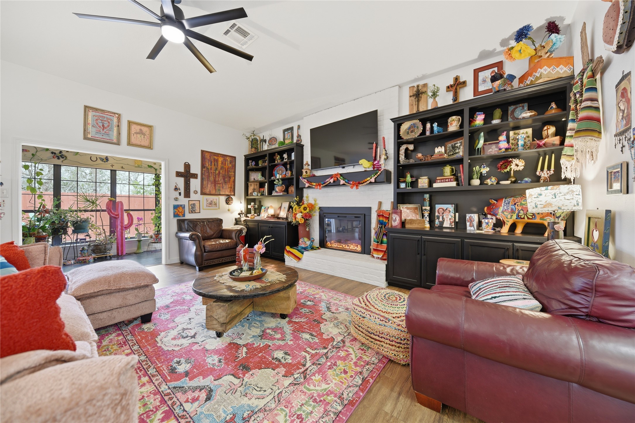 540 Hickory Creek Road Bellville, TX 77418 - Photo 8 of 49 a living room with fireplace furniture and a book shelf