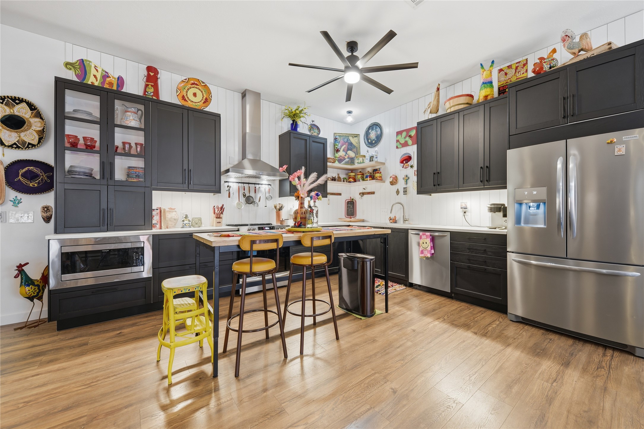 540 Hickory Creek Road Bellville, TX 77418 - Photo 10 of 49 a kitchen with stainless steel appliances kitchen island granite countertop a table chairs and a refrigerator