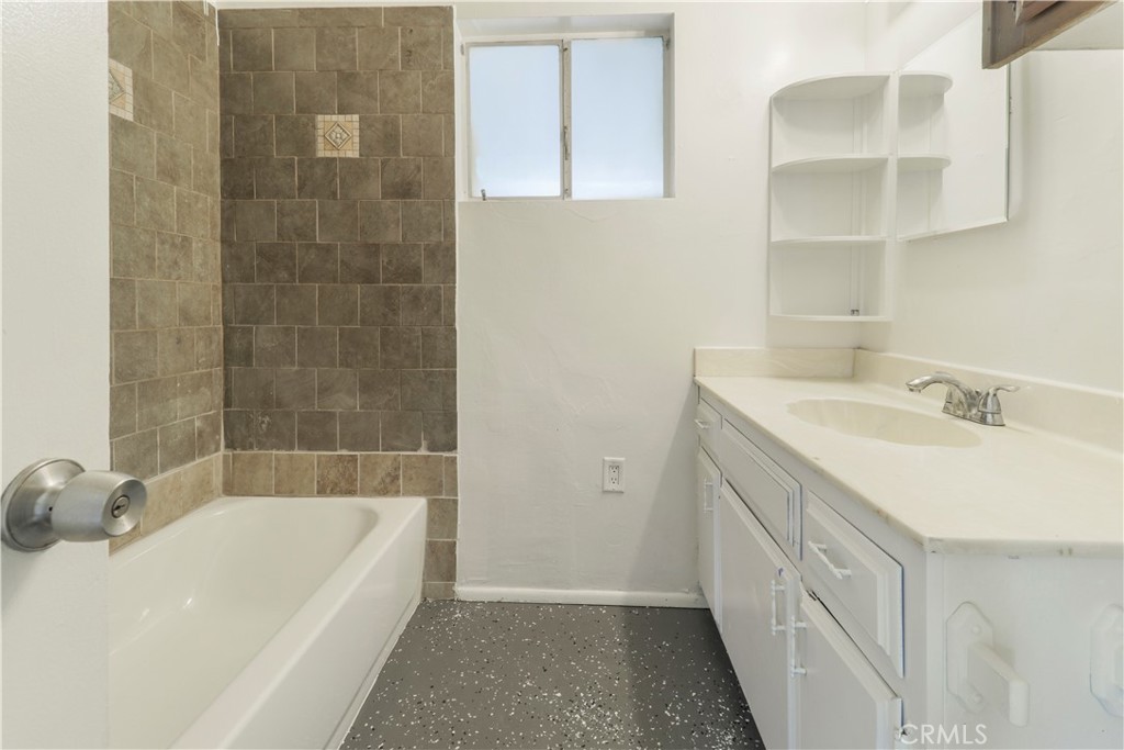 437 North Franklin Street Hemet, CA 92543 - Photo 14 of 25 a bathroom with a tub sink and a mirror