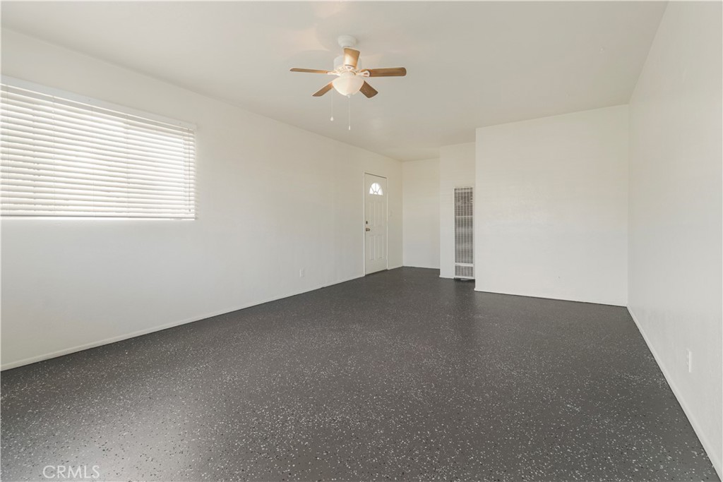 437 North Franklin Street Hemet, CA 92543 - Photo 17 of 25 an empty room with a ceiling fan and a window