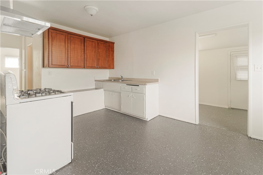 437 North Franklin Street Hemet, CA 92543 - Photo 3 of 25 a kitchen with stainless steel appliances granite countertop a sink stove and cabinets