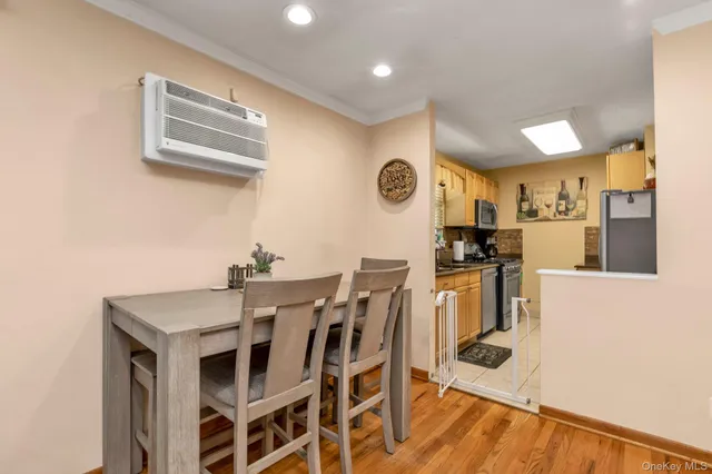 a kitchen with granite countertop a stove a sink and a refrigerator with wooden floor