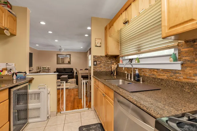 a kitchen with cabinets and chairs