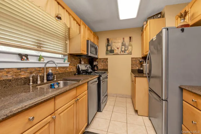 a kitchen with stainless steel appliances a refrigerator sink and cabinets