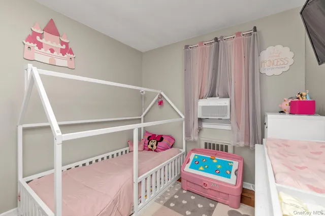 a bedroom with furniture and a baby crib