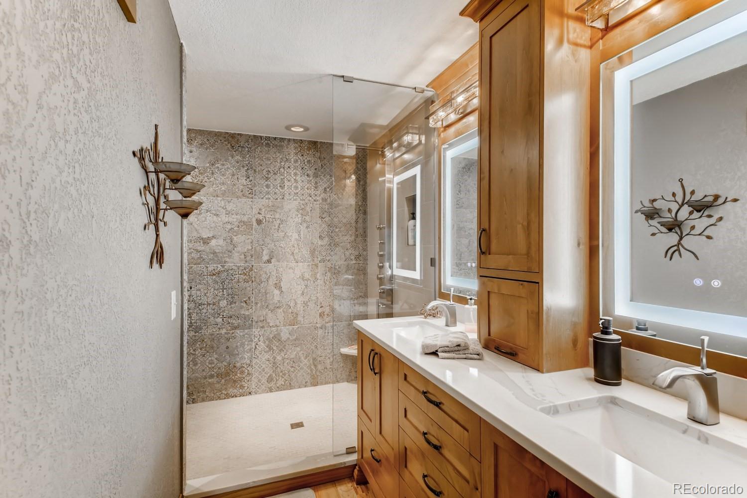 869 Hill And Dale Road, Unit D Golden, CO 80401 - Photo 16 of 27 a bathroom with a granite countertop sink a mirror and a bathtub