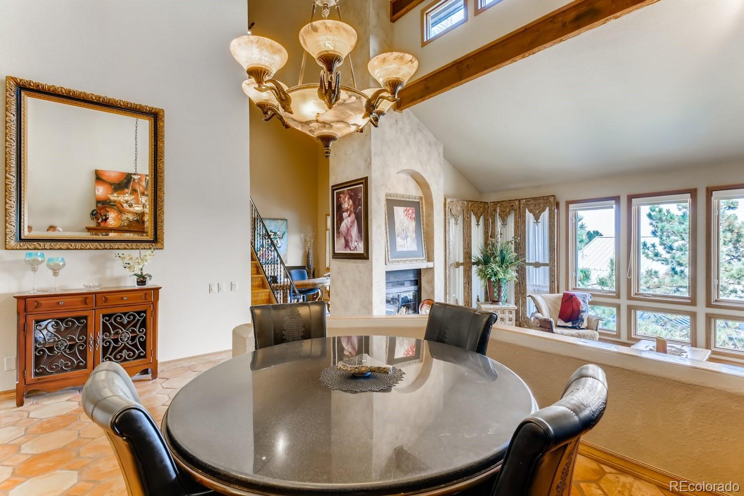 869 Hill And Dale Road, Unit D Golden, CO 80401 - Photo 8 of 27 a dining room with furniture a chandelier and wooden floor