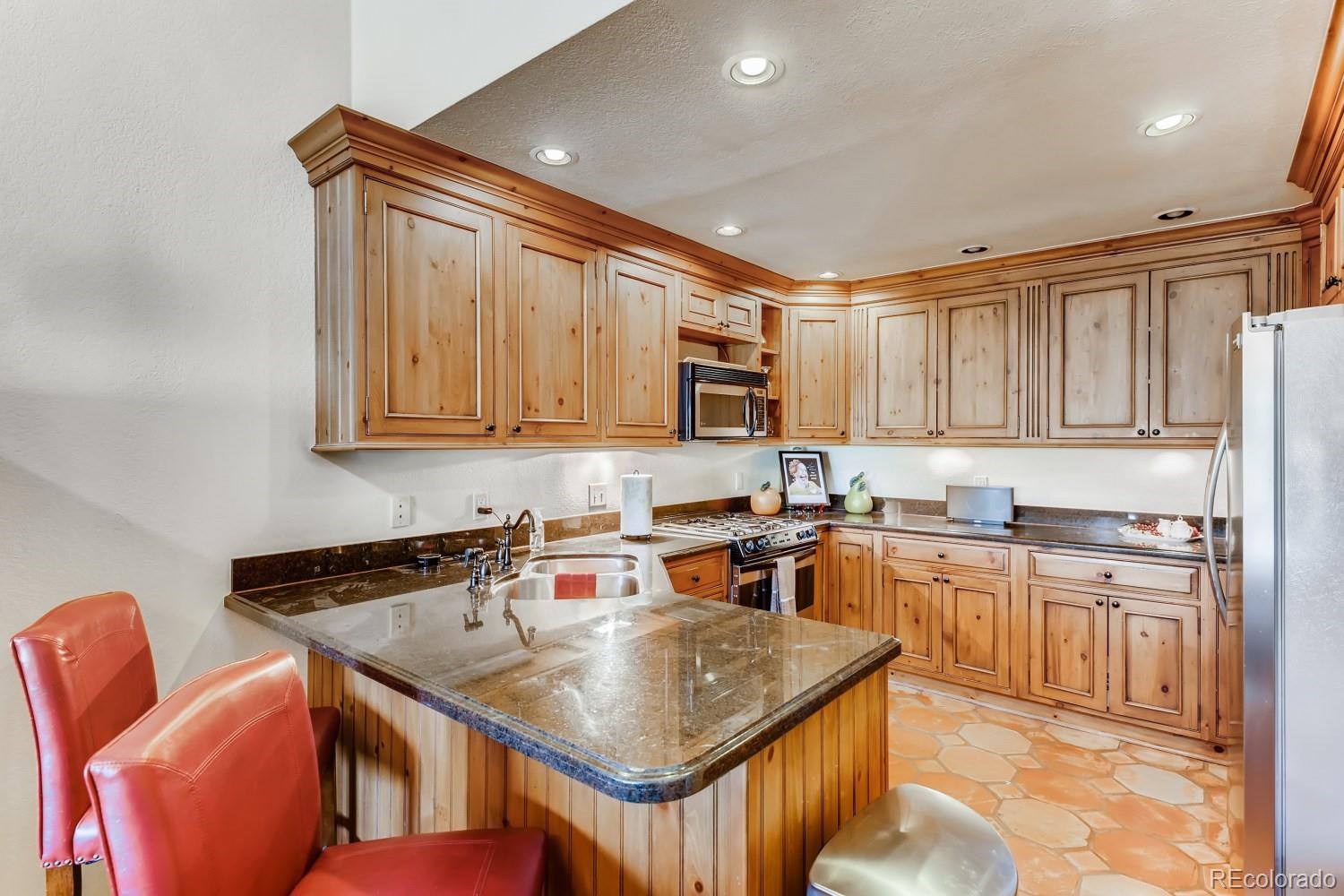 869 Hill And Dale Road, Unit D Golden, CO 80401 - Photo 10 of 27 a kitchen with stainless steel appliances granite countertop a sink a stove and cabinets