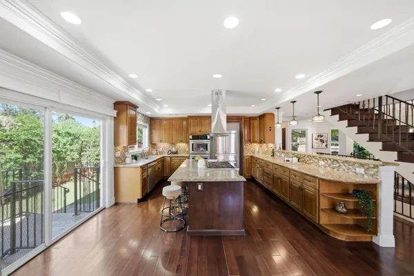 a dining room with furniture window and wooden floor