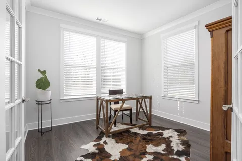 a dining room with wooden floor and a window