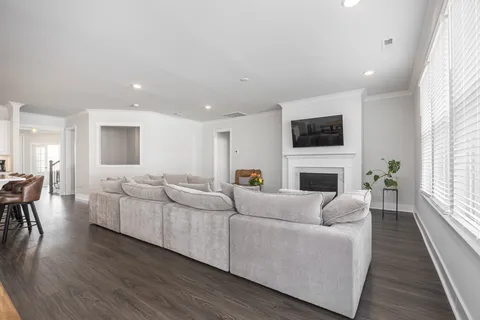 a living room with furniture a fireplace and a flat screen tv