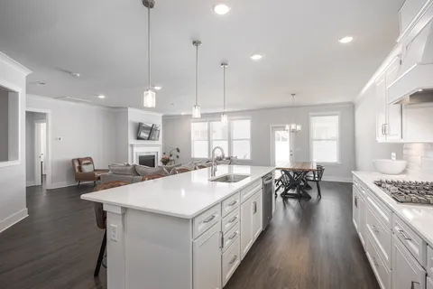 a kitchen with sink stove and cabinets