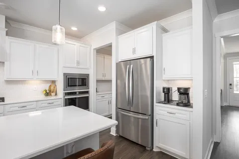 a kitchen with a refrigerator a sink and cabinets
