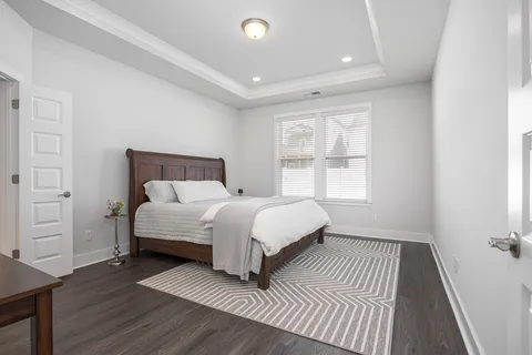 a bedroom with a bed and a view of kitchen