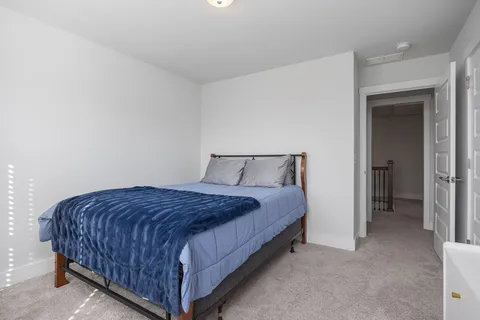 a bedroom with a bed and a couch