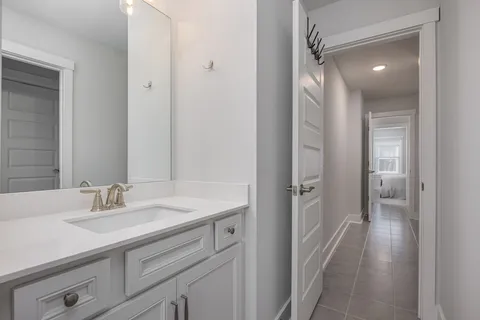 a en suite bathroom with a sink a mirror and a shower