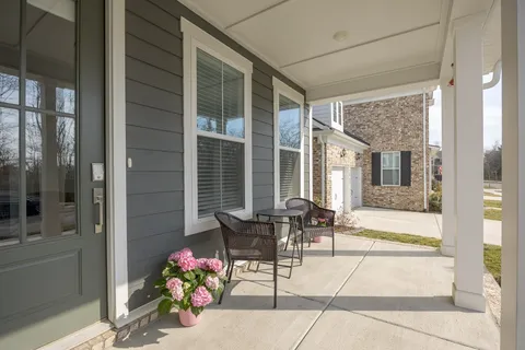 a view of a patio with table and chairs and potted plants