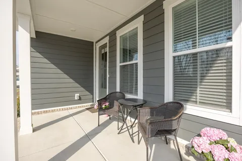a balcony with with a bench and a potted plant