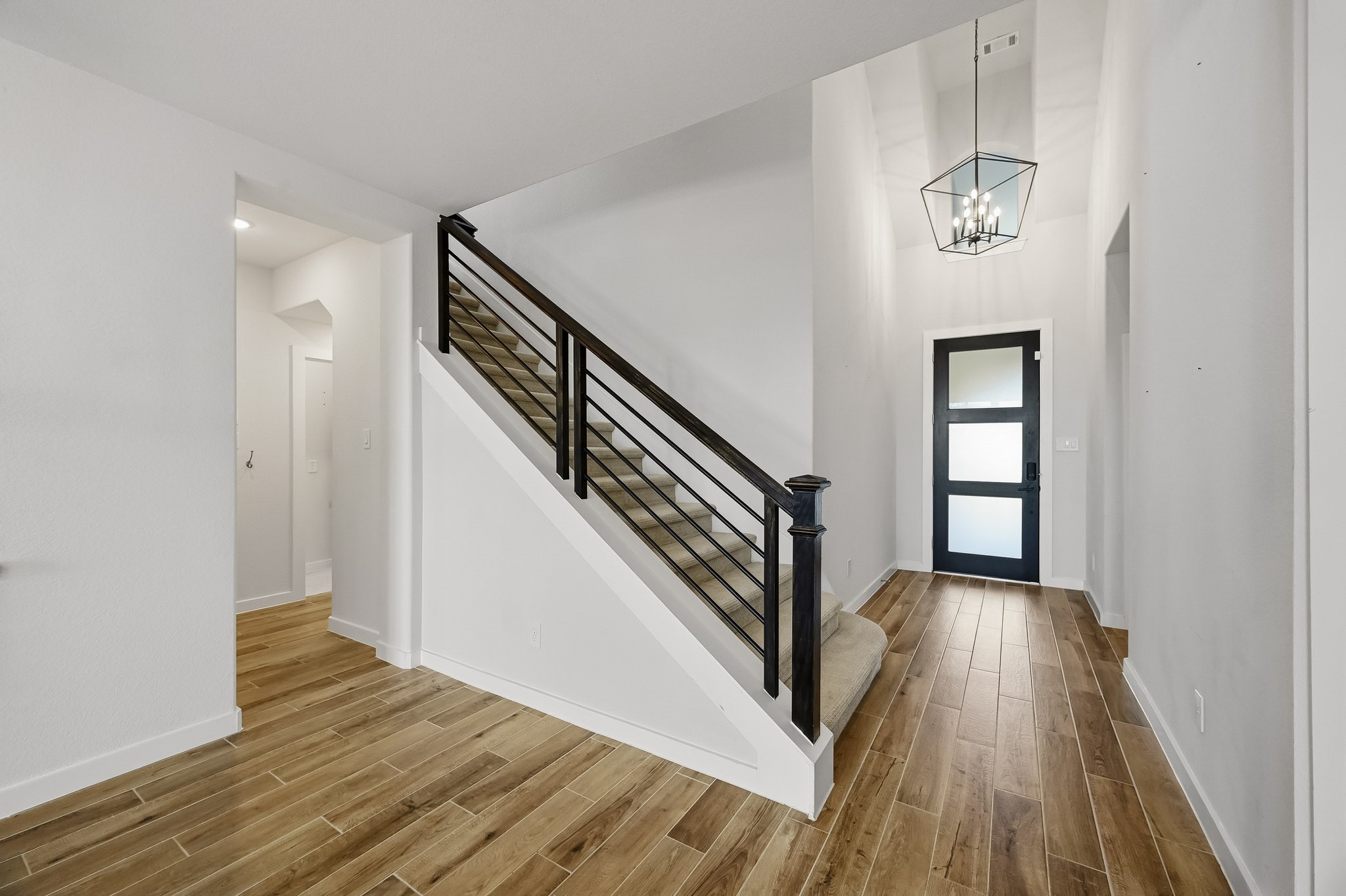 6718 Waxbill Road Katy, TX 77493 - Photo 16 of 30 Heading back to the front of the home you see the open entry way leading to the downstairs secondary bedroom with a full bathroom and upstairs to a large game room, media room, and 2 additional bedrooms.