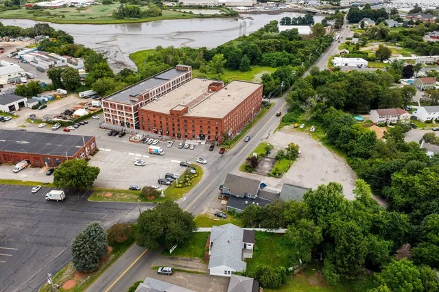 an aerial view of a house with a lake view