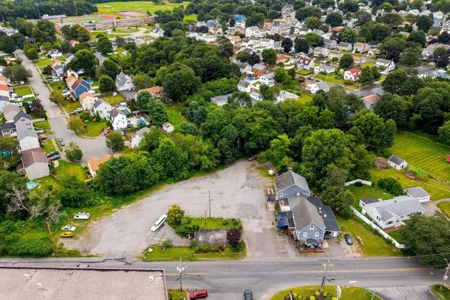 an aerial view of a house with a yard basket ball court