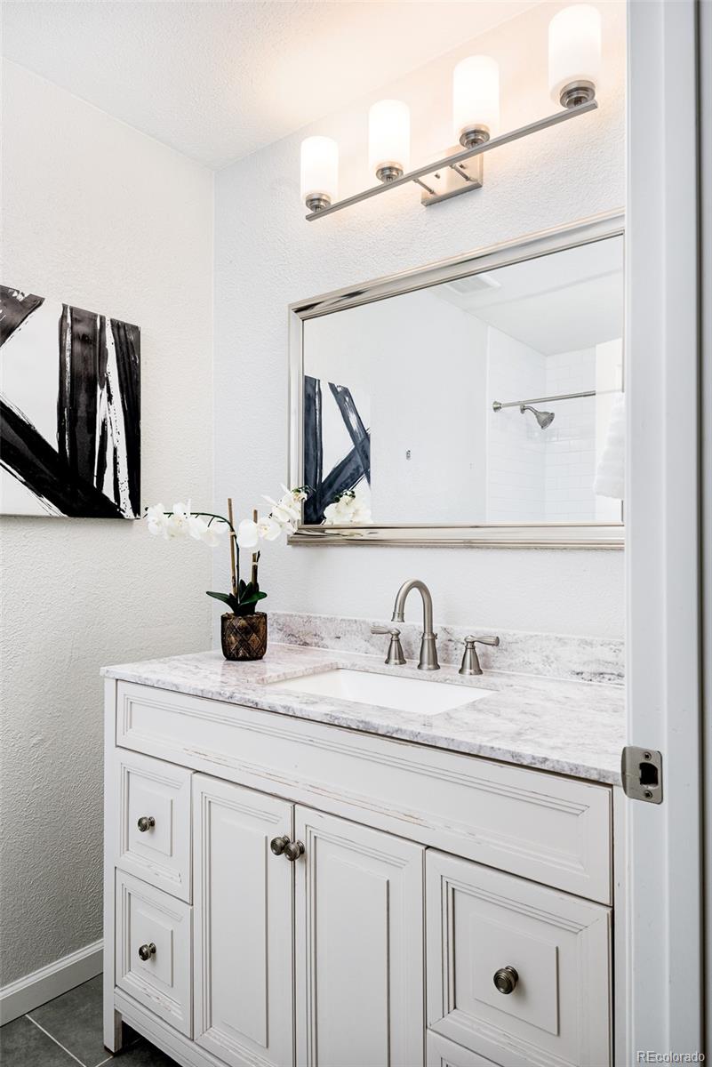13492 Jackson Drive Thornton, CO 80241 - Photo 11 of 25 a bathroom with a sink and a mirror