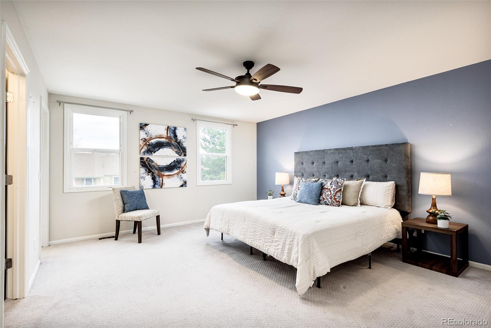 13492 Jackson Drive Thornton, CO 80241 - Photo 12 of 25 a bedroom with a bed and a chandelier