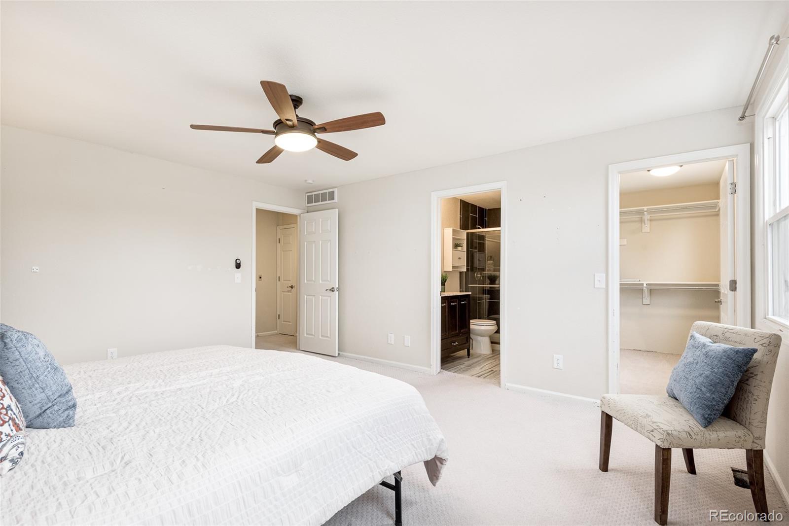 13492 Jackson Drive Thornton, CO 80241 - Photo 13 of 25 a bedroom with a bed and chair