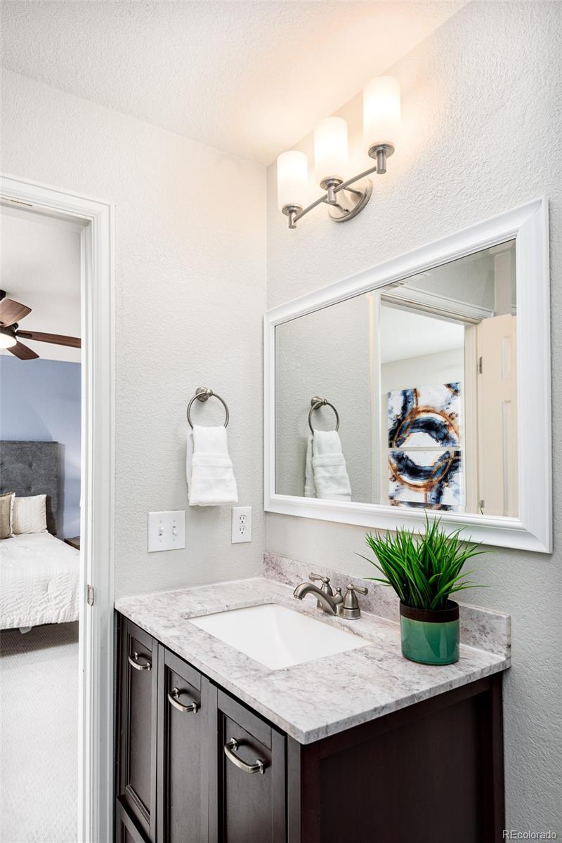 13492 Jackson Drive Thornton, CO 80241 - Photo 14 of 25 a bathroom with a sink and a mirror