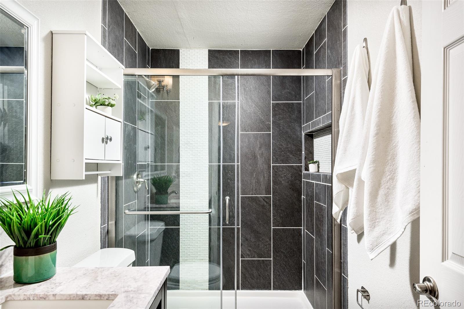 13492 Jackson Drive Thornton, CO 80241 - Photo 15 of 25 a bathroom with a shower and a sink