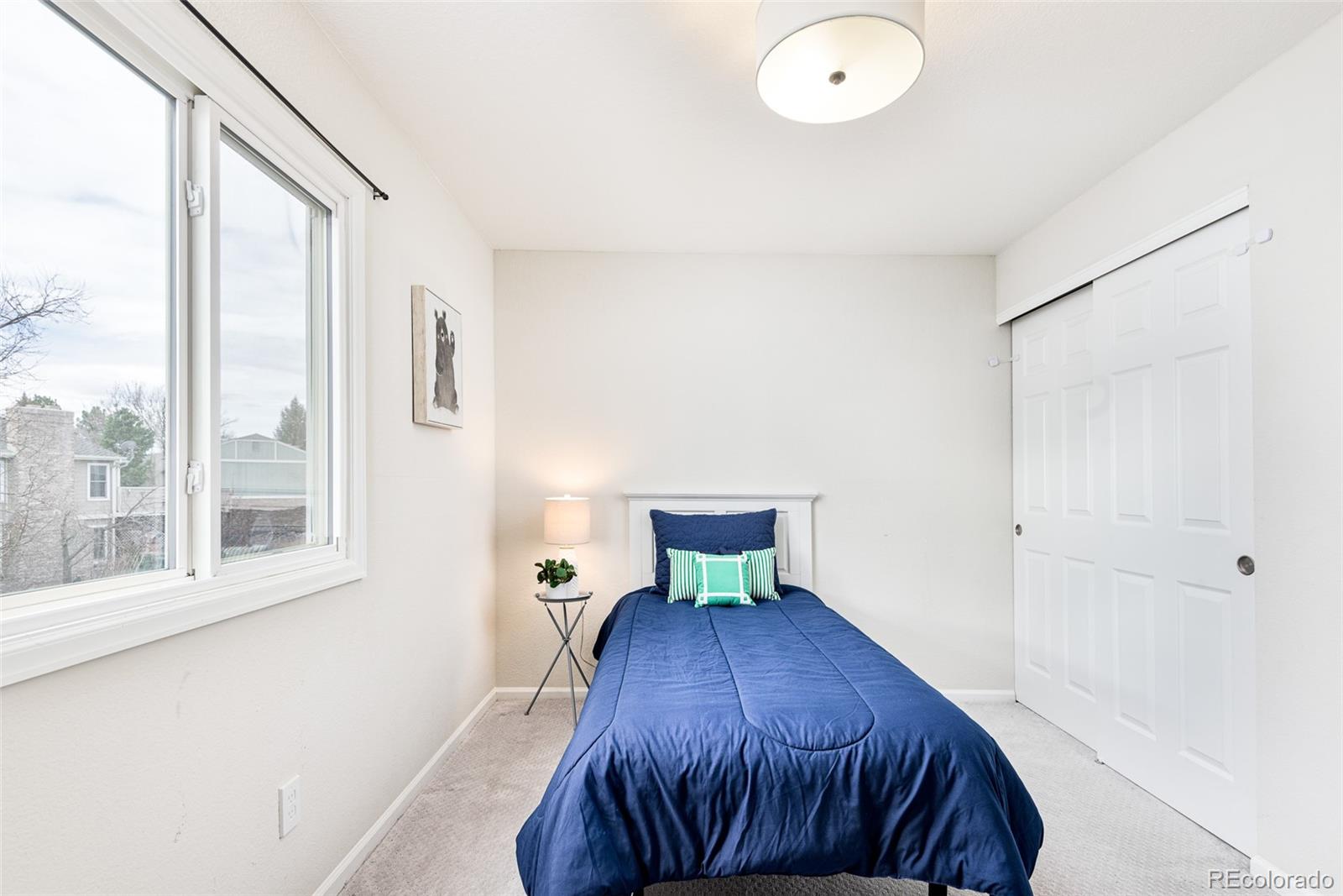 13492 Jackson Drive Thornton, CO 80241 - Photo 17 of 25 a bedroom with a bed and a window