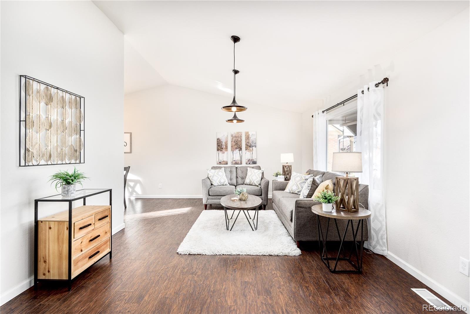 13492 Jackson Drive Thornton, CO 80241 - Photo 4 of 25 a living room with furniture and a wooden floor