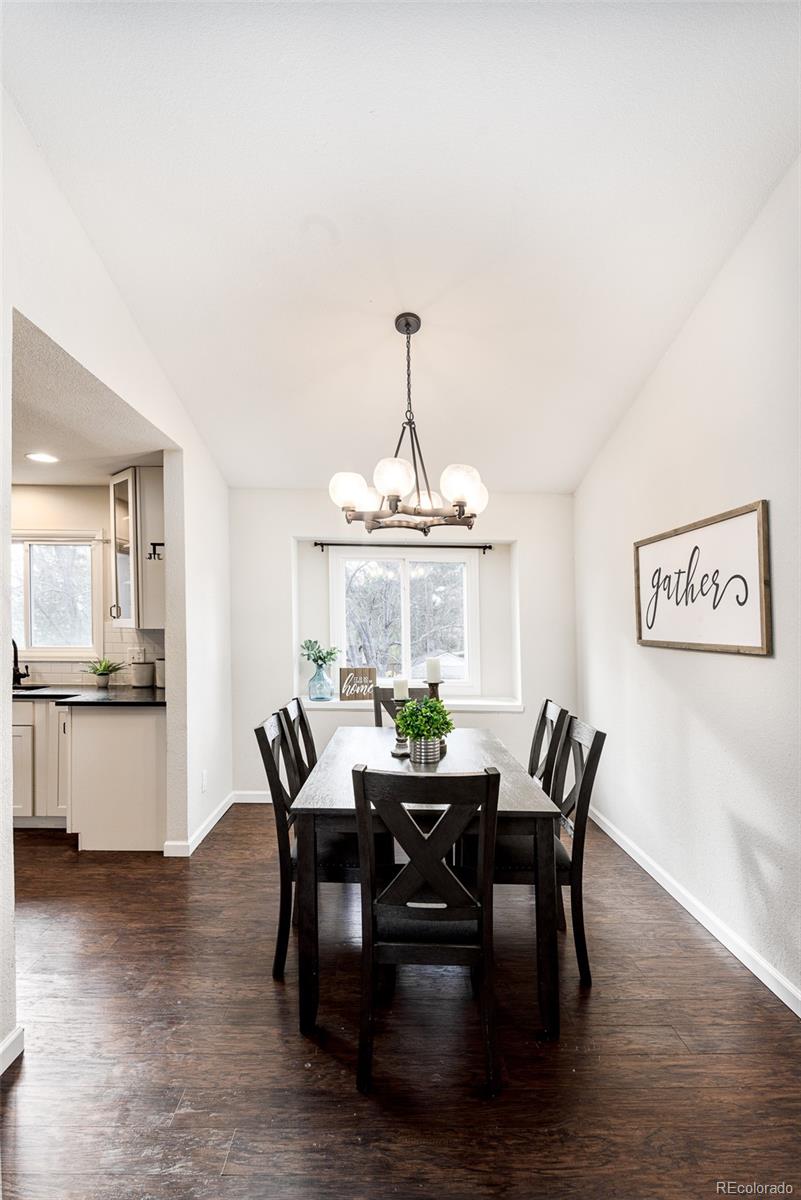 13492 Jackson Drive Thornton, CO 80241 - Photo 6 of 25 a view of a dining room with furniture window and wooden floor