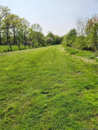 a view of a field with an trees