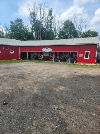 a view of a red house with a yard