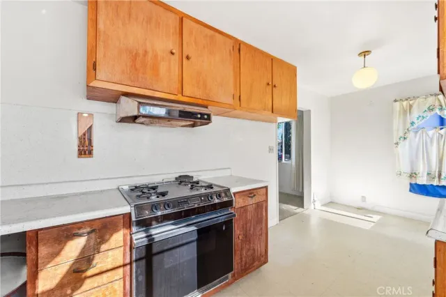 a kitchen with stainless steel appliances granite countertop a stove and a microwave