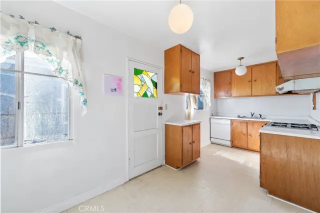 walk in closet with window and a kitchen