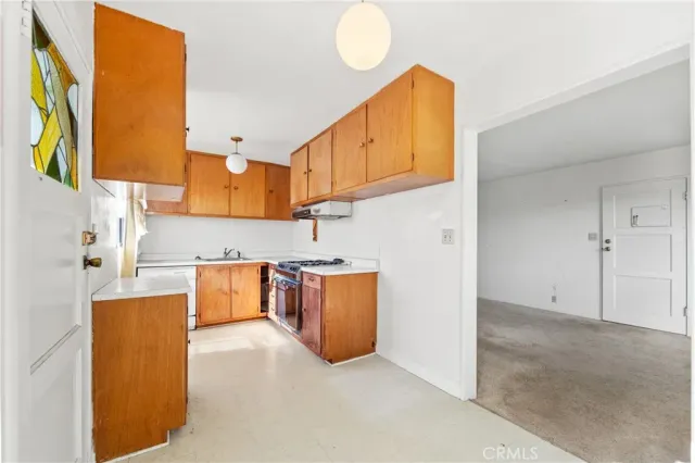 a kitchen with stainless steel appliances granite countertop a sink and a refrigerator