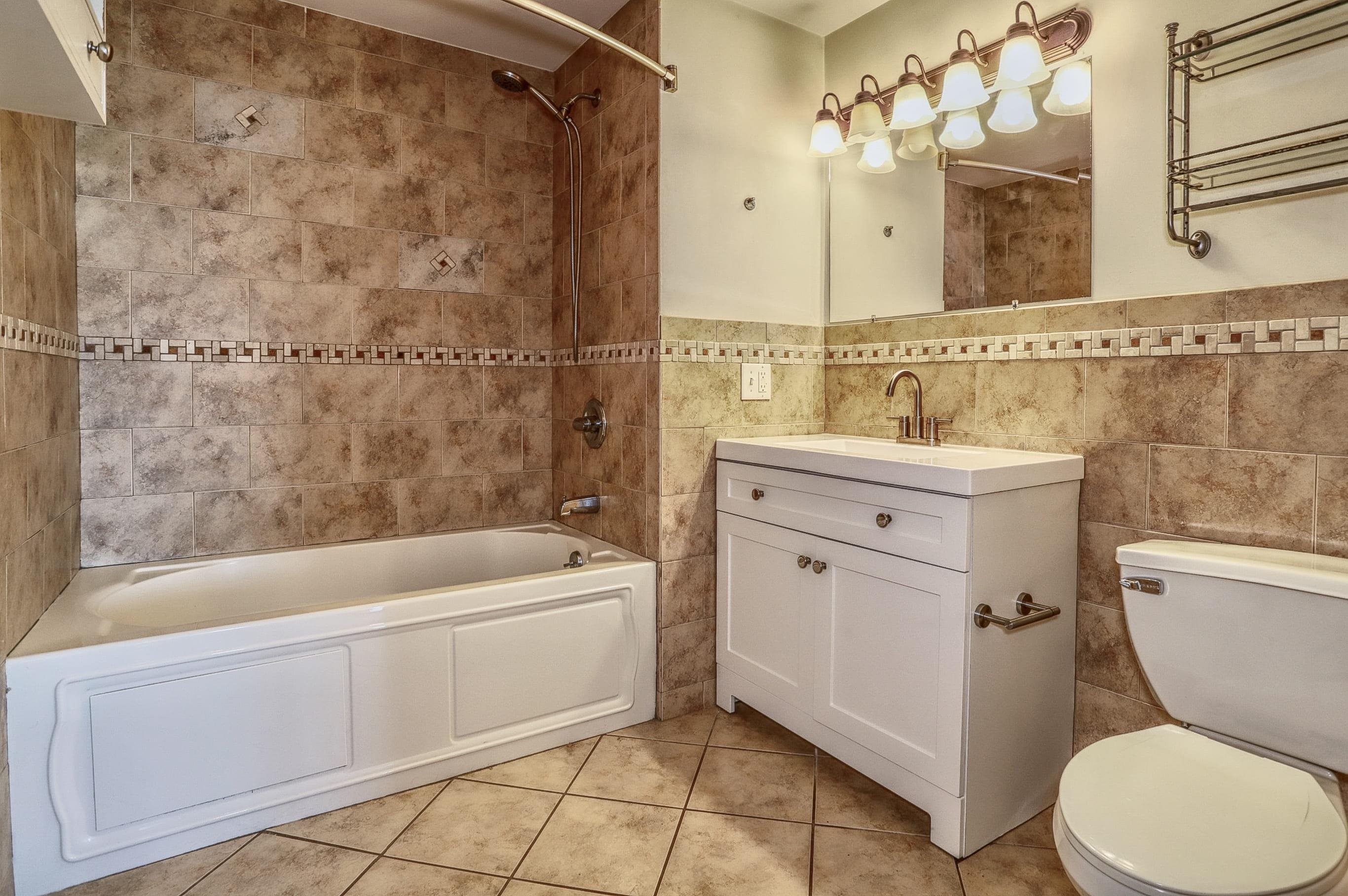 1720 New York Avenue, Unit 406 Union City, NJ 07087 - Photo 16 of 21 a bathroom with a sink a toilet and shower