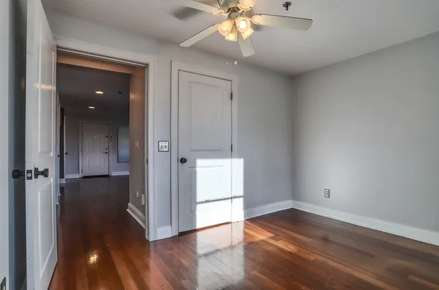 a view of room with window and wooden floor