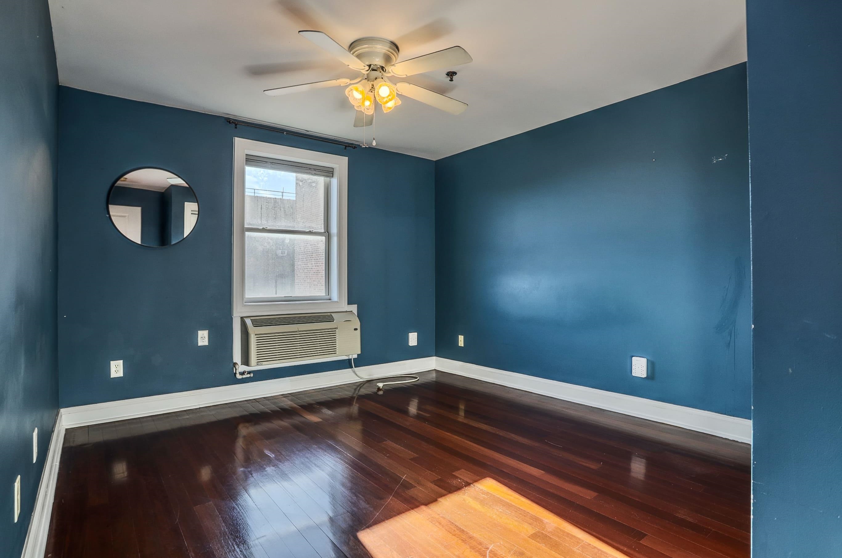 1720 New York Avenue, Unit 406 Union City, NJ 07087 - Photo 19 of 21 a view of room with window and wooden floor