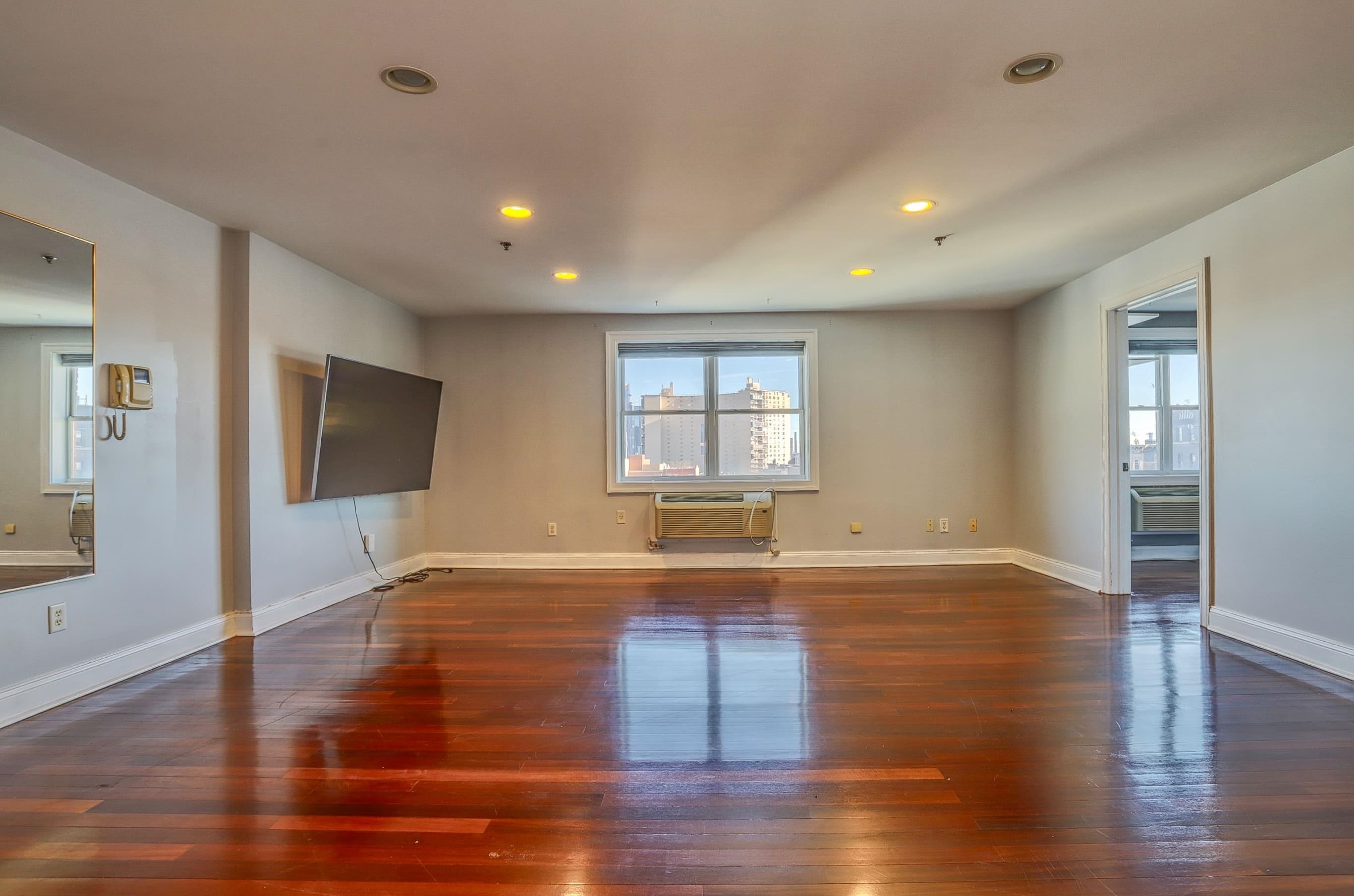 1720 New York Avenue, Unit 406 Union City, NJ 07087 - Photo 4 of 21 a view of empty room with wooden floor and fan